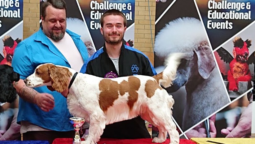 Tim with a trophy and a Cavalier King Charles Spaniel at competition
