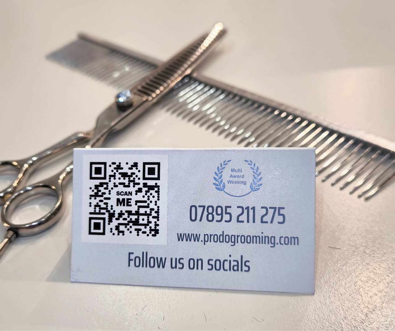 Pro Dog Grooming business card with grooming scissors and comb